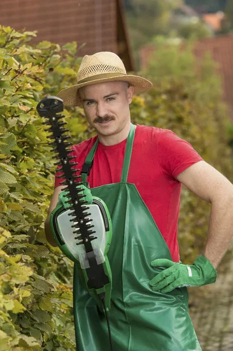 Framed Print : Gardener using a hedge trimmer Print Framed Print : Gardener using a hedge trimmer Print