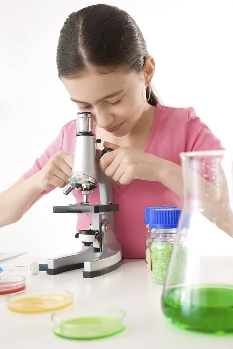 Framed Print : Girl using a microscope, working in a laboratory Print Framed Print : Girl using a microscope, working in a laboratory Print
