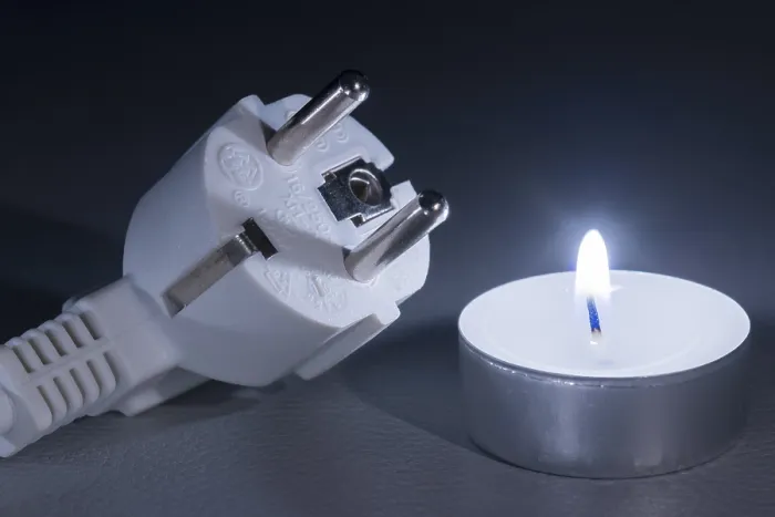 Framed Print : Glowing Candle Next to Electrical Plug Print