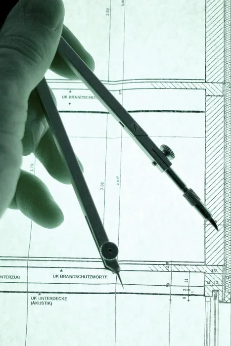 Framed Print : Hand with Dividers on Construction Plan Print