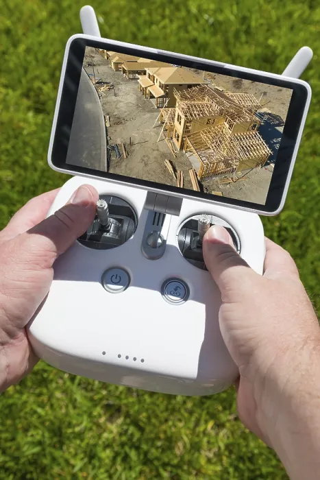 Framed Print : Hands holding drone controller with construction framing Print Framed Print : Hands holding drone controller with construction framing Print
