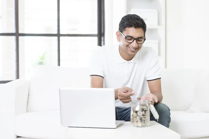Framed Print : Indian Man at Home with Computer and Coins Print Framed Print : Indian Man at Home with Computer and Coins Print