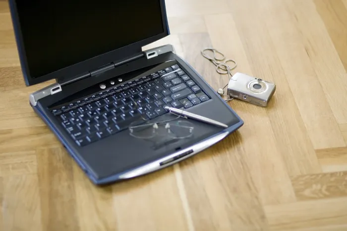 Framed Print : Laptop and digital camera on the floor Print Framed Print : Laptop and digital camera on the floor Print