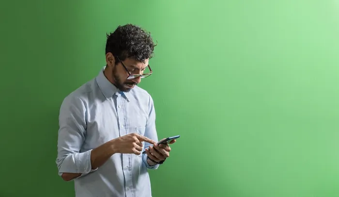 Framed Print : Young Man Checking His Cell Phone Print Framed Print : Young Man Checking His Cell Phone Print