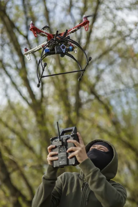 Framed Print : Man in Mask Operating a Drone with Remote Control Print Framed Print : Man in Mask Operating a Drone with Remote Control Print