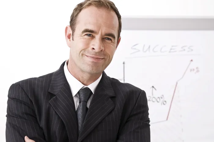 Framed Print : Manager Smiling Print - Standing in Front of Flipchart Framed Print : Manager Smiling Print - Standing in Front of Flipchart