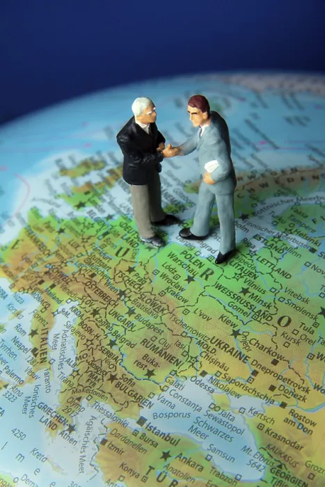 Framed Print : Globalisation: Two Managers on One Globe Print Framed Print : Globalisation: Two Managers on One Globe Print