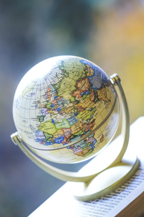 Framed Print : Miniature Globe Print on Stack of Books Framed Print : Miniature Globe Print on Stack of Books