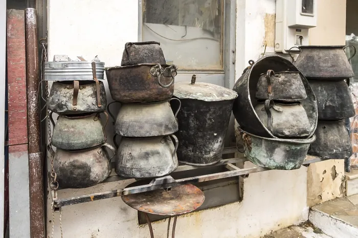 Framed Print : Several old cauldrons in heap in front of a facade Print Framed Print : Several old cauldrons in heap in front of a facade Print