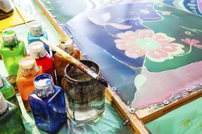 Framed Print : Paints, Brushes and Silky Batik Print in Workshop Framed Print : Paints, Brushes and Silky Batik Print in Workshop