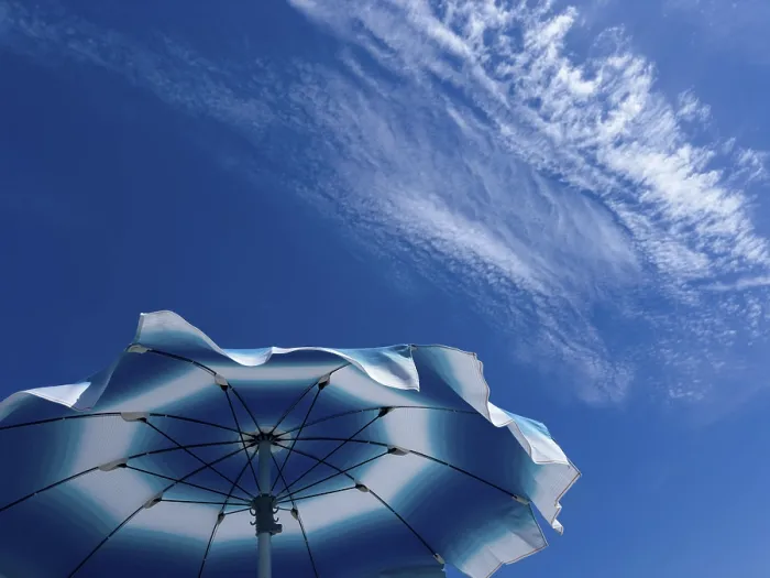 Framed Print : Parasol in front of a blue sky with clouds Print Framed Print : Parasol in front of a blue sky with clouds Print