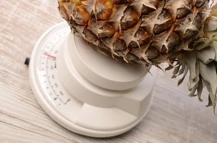 Framed Print : Pineapple on a Scale Print by imageBROKER