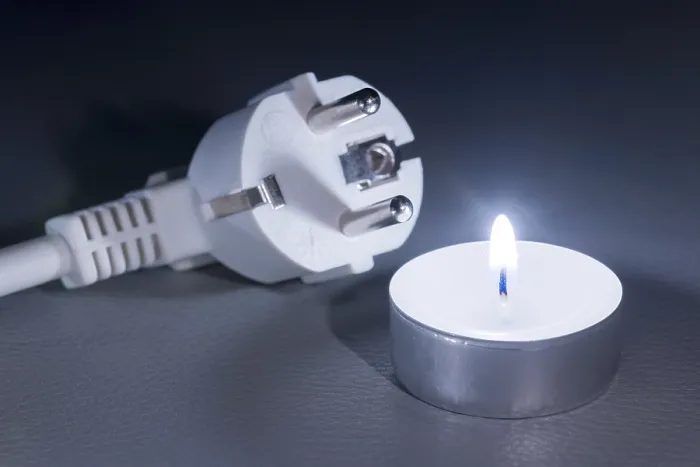 Framed Print : There is a plug next to a burning candle that glows in the dark Print Framed Print : There is a plug next to a burning candle that glows in the dark Print