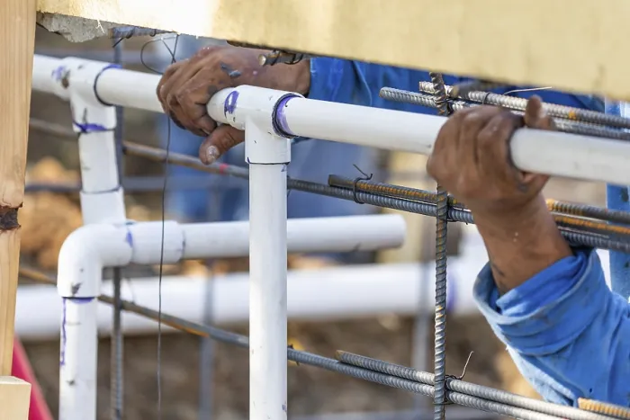 Framed Print : Plumber installing PVC pipe at construction site print Framed Print : Plumber installing PVC pipe at construction site print