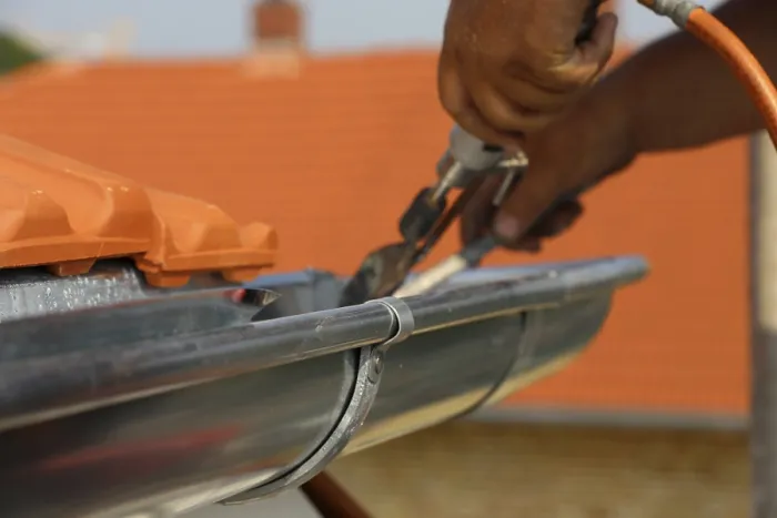 Framed Print : Roofer doing tinsmith work on a gutter Print Framed Print : Roofer doing tinsmith work on a gutter Print