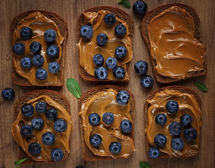 Framed Print : Rye bread with peanut paste and blueberries print, top view Framed Print : Rye bread with peanut paste and blueberries print, top view