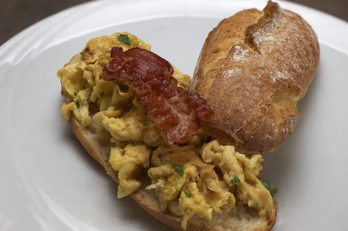 Framed Print : Scrambled eggs with fried bacon on a rustic roll Print Framed Print : Scrambled eggs with fried bacon on a rustic roll Print