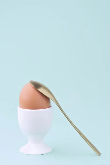 Framed Print : A Single Brown Egg Print on Soft Blue Background Framed Print : A Single Brown Egg Print on Soft Blue Background