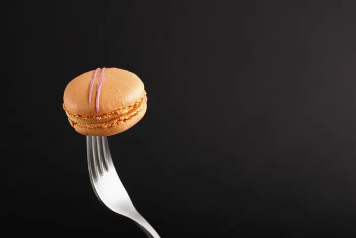 Framed Print : Single Orange Macaron Print on Black Background Framed Print : Single Orange Macaron Print on Black Background