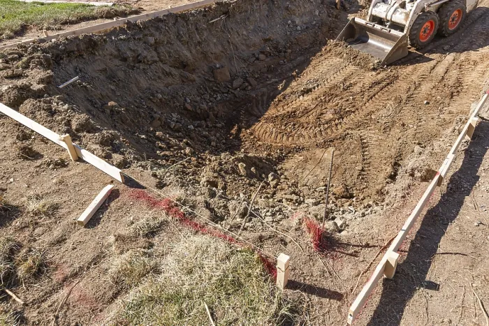 Framed Print : Small Bulldozer Digging in Yard for Pool Installation Print