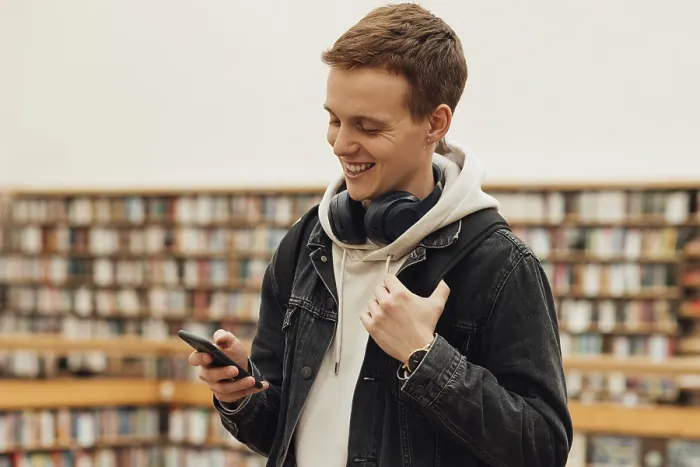 Framed Print : Smiling Student Using Smartphone Print Framed Print : Smiling Student Using Smartphone Print
