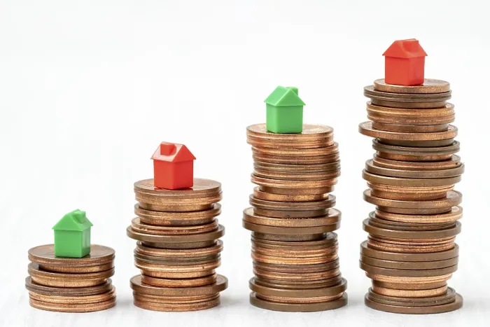 Framed Print : Stacked Coins with Mini Houses Print Framed Print : Stacked Coins with Mini Houses Print
