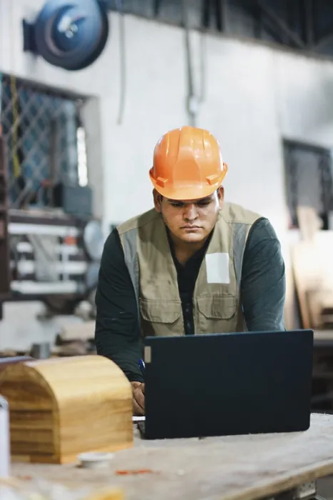Framed Print : Print of Carpenter Working with Laptop in Workshop Framed Print : Print of Carpenter Working with Laptop in Workshop