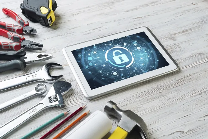 Framed Print : Tablet PC with Security Concept and Industrial Tools Print