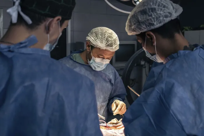 Framed Print : Team of doctors in an operating room print Framed Print : Team of doctors in an operating room print