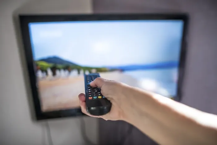 Framed Print : Hand Holding Remote Control and TV Print Framed Print : Hand Holding Remote Control and TV Print
