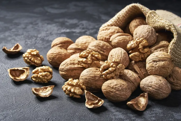 Framed Print : Walnuts in a bag on black background Print with spaces Framed Print : Walnuts in a bag on black background Print with spaces
