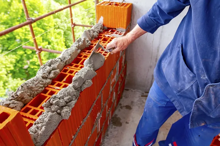 Framed Print : Worker Applying Mortar to Red Blocks Print Framed Print : Worker Applying Mortar to Red Blocks Print