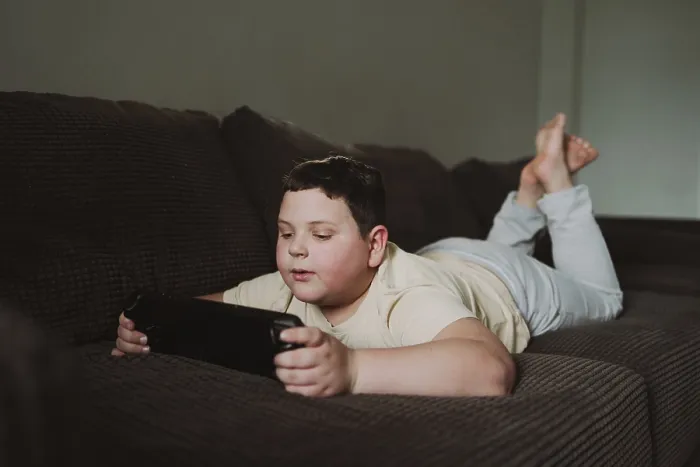 Framed Print : Young Boy Gaming on Brown Sofa Print Framed Print : Young Boy Gaming on Brown Sofa Print