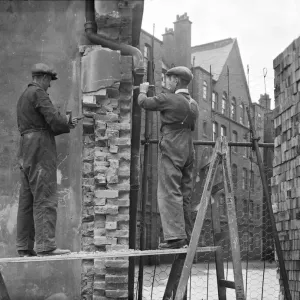 Print of workmen repairing bomb damage to Millbank Estate flats Print of workmen repairing bomb damage to Millbank Estate flats