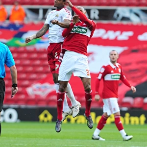 Bristol Citys Marvin Elliott battles for the ball in the air with Middlesbroughs Mickael Tavares