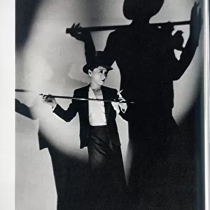 Anna May Wong, actress, studio portrait with top hat and cane. With description, A fantastic camera-study of this well-known actress by Cannons, the English photographer of Hollywood