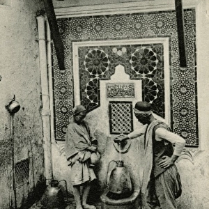 Arabs at a water fountain in Algiers, Algeria