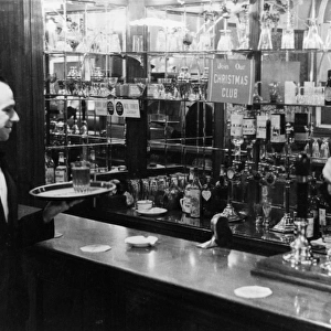 Barman and waiter working in a bar