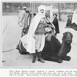 Baroness Troil in Arab dress with a camel, Biskra, Sahara