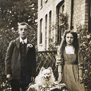 Boy, girl and dog in garden
