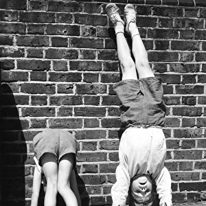 Boys doing handstands on a Balham street, SW London