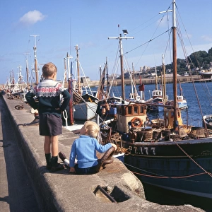 Boys and fishing boats in Newlyn Harbour, Cornwall