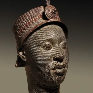 Bronze head with beaded crown and plume. 12th-14th