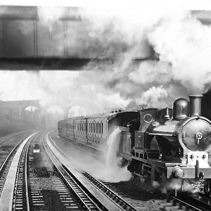 Bushey Steam Train picking up water early 1900s