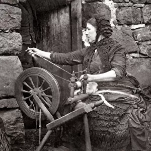 c. 1880s Scotland - woman spinning wool on a spinning wheel