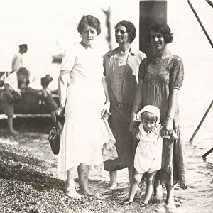 Candid seaside photograph - 3 women and child - under pier