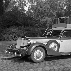Car with suitcases on roof rack - Germany post-war