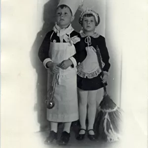 Two children in fancy dress; the little boy is dressed as a chef while a little girl