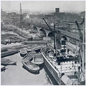 East London and Regents Canal Dock in Limehouse, showing barges waiting for access to