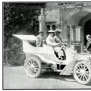 Three Edwardian people in a veteran car